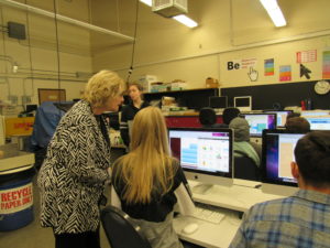 Board Member, former teacher, Laurel Leidner gets a graphics lesson from student