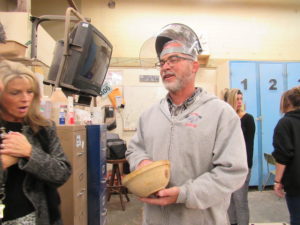 Pete Ferrara, Wood Shop and Metal Shop teacher shows Rim Educ. Board how a wood bowl is turned